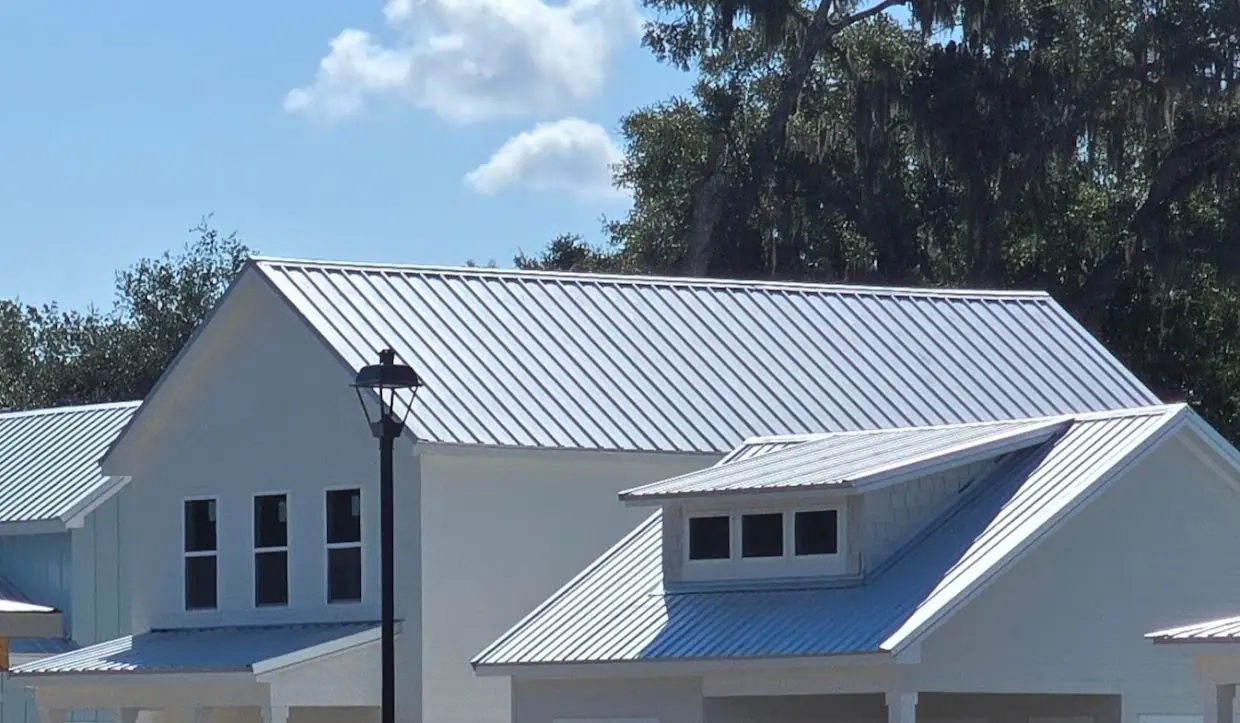New homes roofed with DynaRib R36 / Shadow Wall R36 panels, including a shed dormer