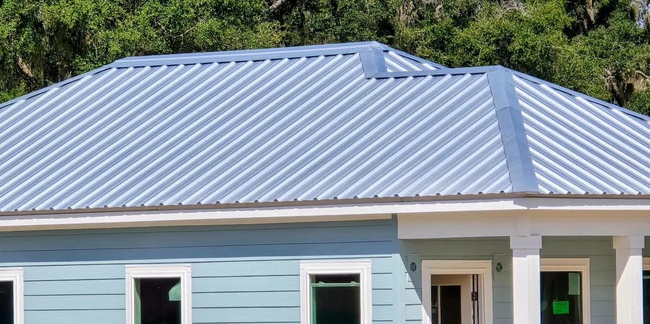 Hip roof finished in DynaRib R36 / Shadow Wall R36 roof panels with matching hip and ridge trim